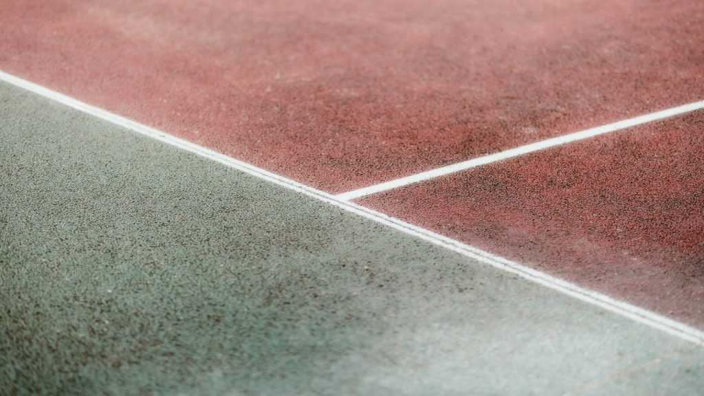 A tennis racket and ball on a tennis court